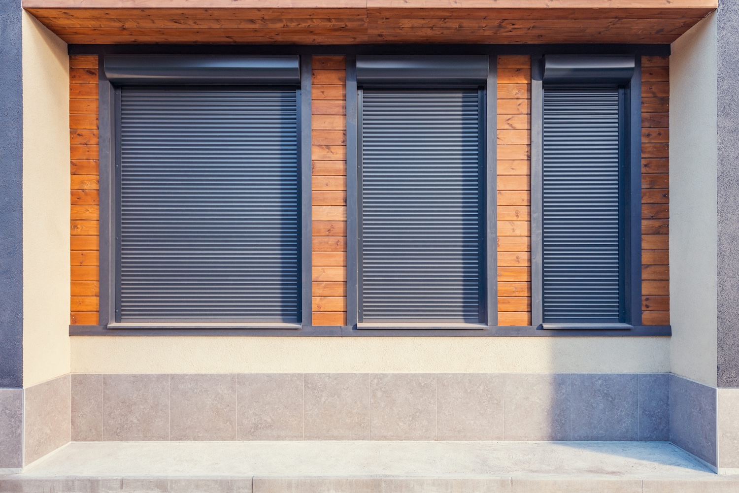 Three closed windows of the small street cafe.